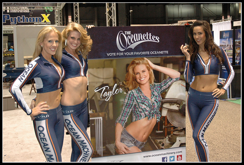 The word famous Oceanettes, Emily Taylor and Shannon with a lifesize poster of Taylor from the 2014 Oceanette Calendar