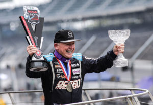 A jubilant Danny Steyn receives the 2021 SCCA Super Touring Lite winners trophy, and the esteemed Super Sweep Award at the Indianapolis Motor Speedway